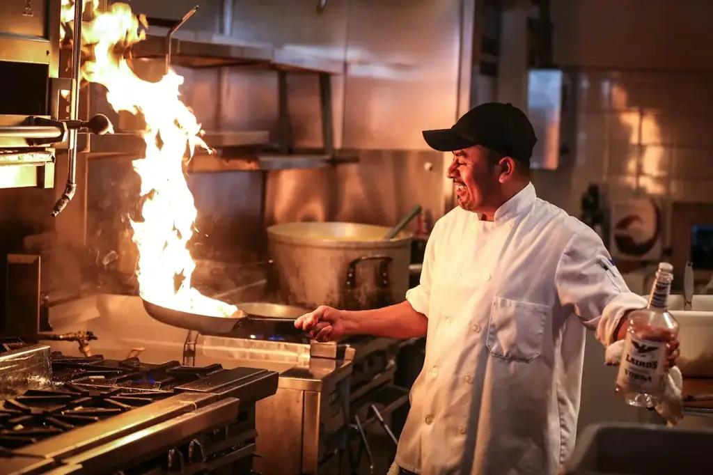 The cook at the wood fire in the example restaurant's kitchen