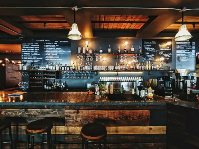 The bar at Ember and Oak in the evening, lit with hanging lamps
