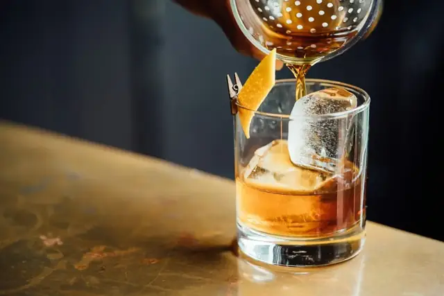 Old fashioned poured over a large ice cube